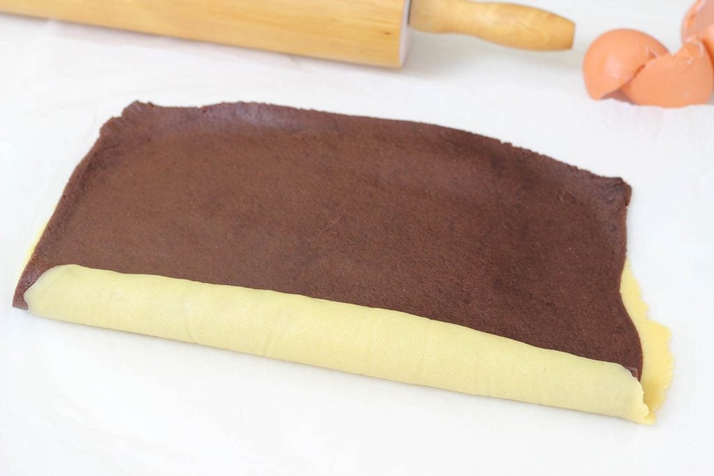 Stendiamo un po' le frolle con il mattarello per farle aderire bene e arrotoliamole su se stesse fino a formare un rotolo. Lasciamo riposare il rotolo per circa 10-15 minuti in freezer. Nel frattempo prepariamo la crema al cioccolato.
