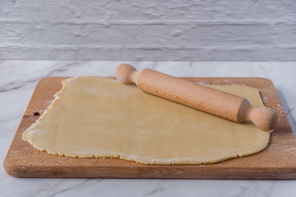 Stendiamo con il mattarello l’impasto per biscotti su una spianatoia infarinata fino a ottenere uno spessore di circa 4-5 mm.